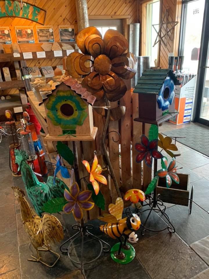 A store filled with lots of decorations including a birdhouse and a bee statue.