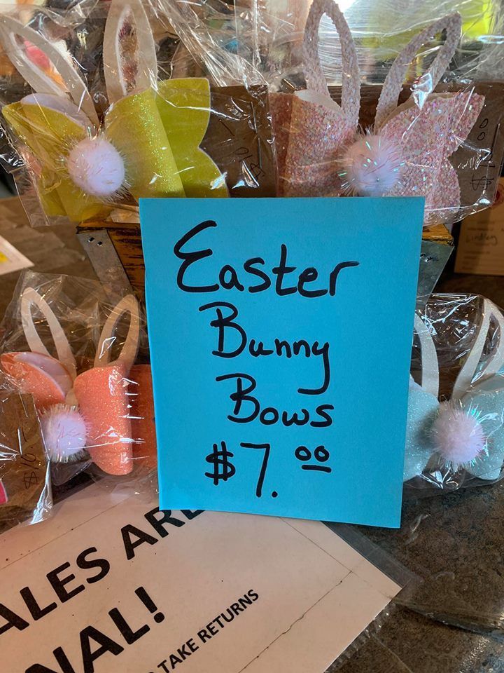 A sign that says easter bunny bows on it