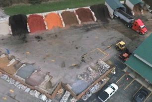 An aerial view of a warehouse with trucks parked in front of it