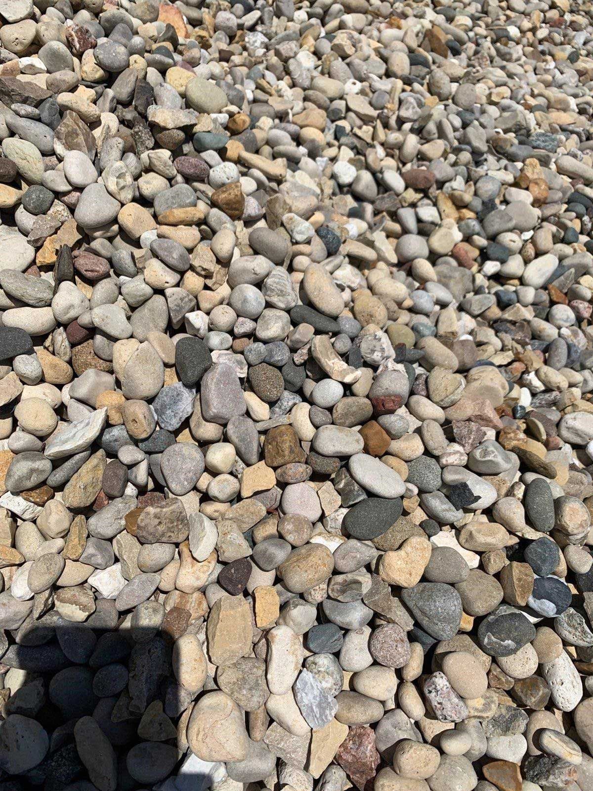 A pile of rocks sitting on top of each other on a beach.