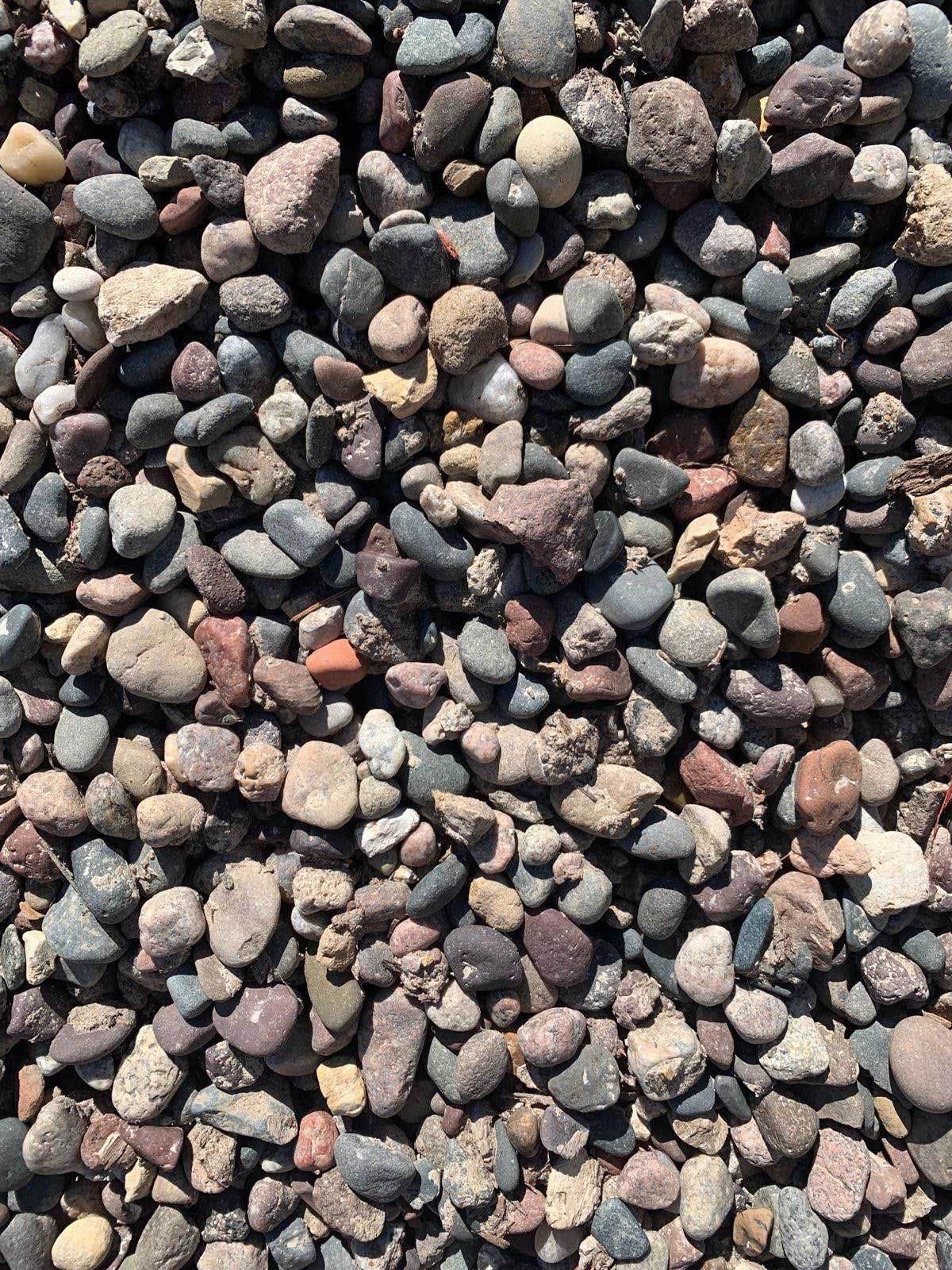 A pile of rocks sitting on top of each other on the ground.