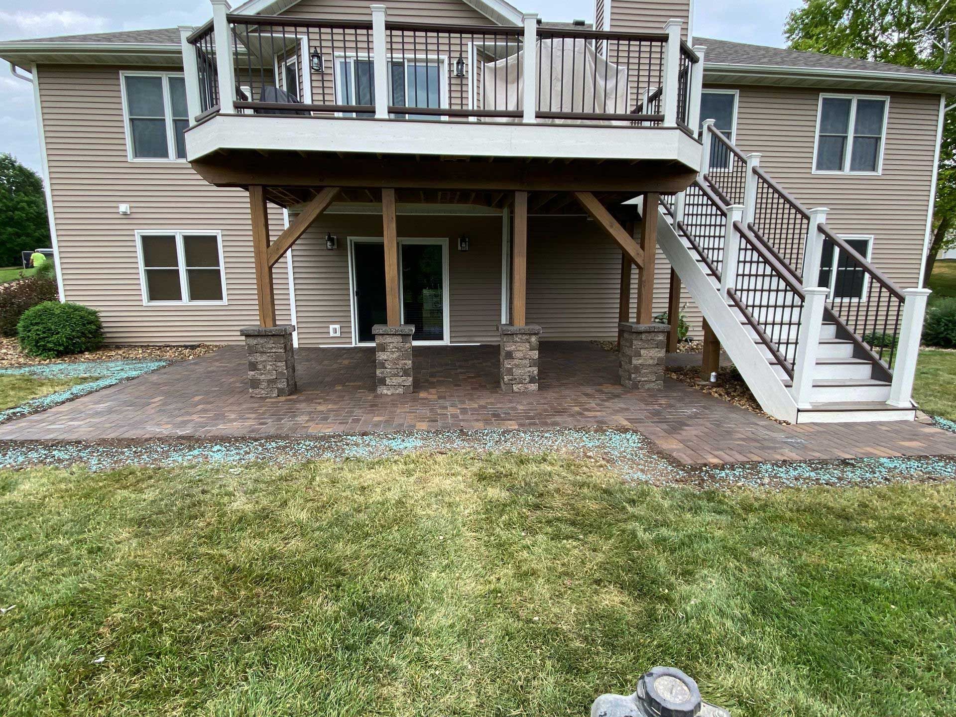 The back of a house with a large deck and stairs.