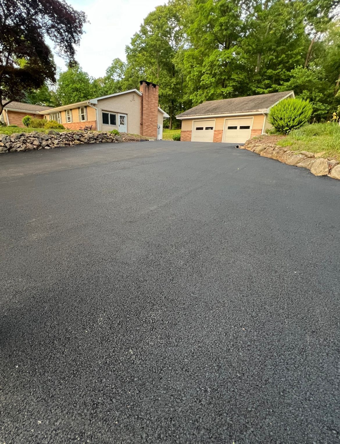 A driveway leading to a house with a garage