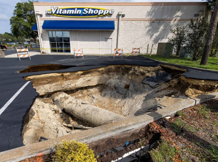 A sinkhole has formed in the parking lot