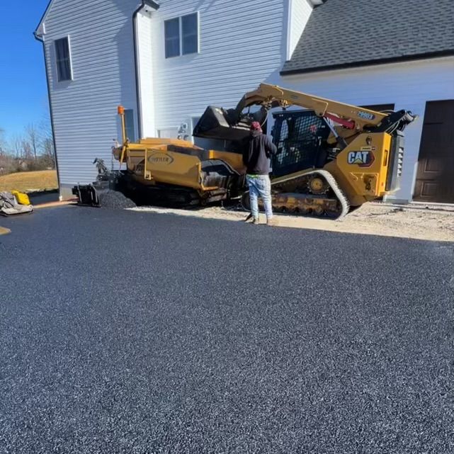 A man is standing in front of a CAT bulldozer