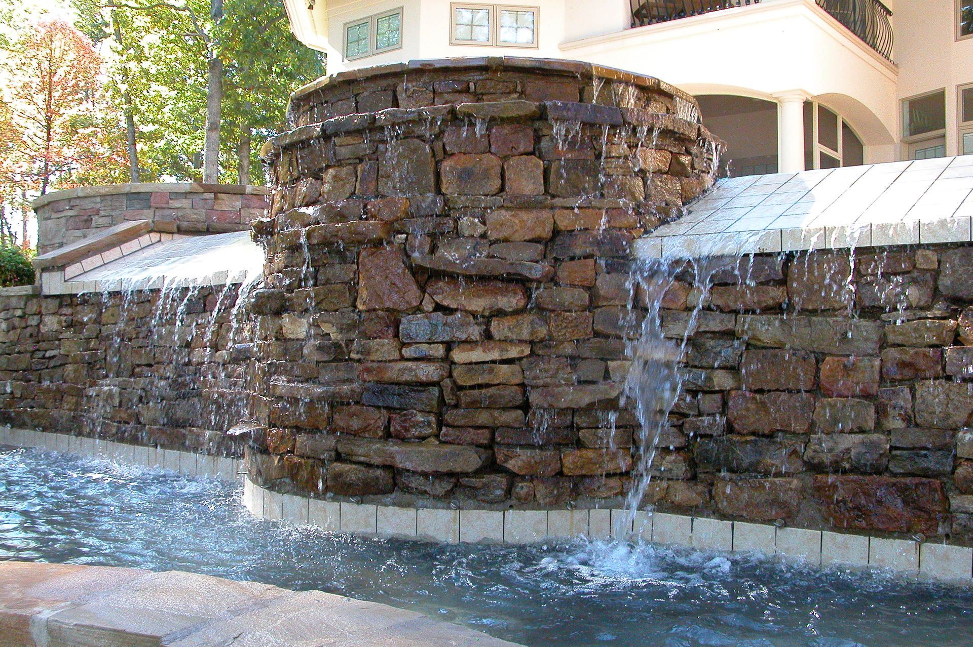 Stone fountain with cascading water in a courtyard