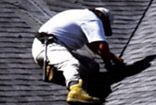 A man is working on a roof with a ladder.