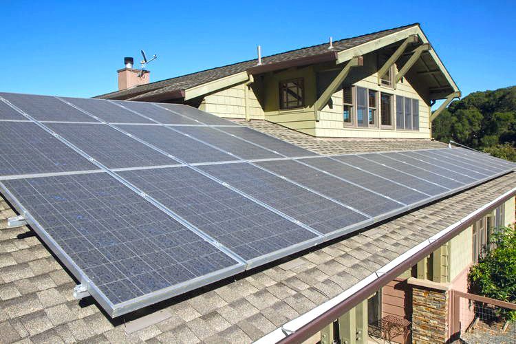 A house with a lot of solar panels on the roof