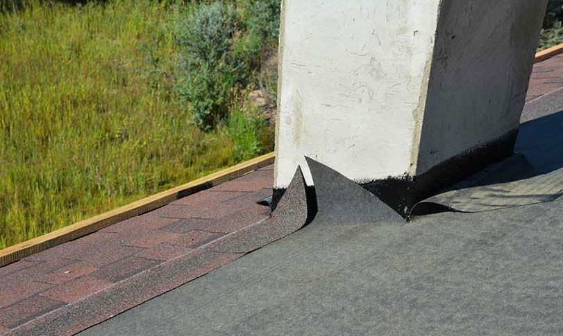 A chimney is sitting on top of a roof.