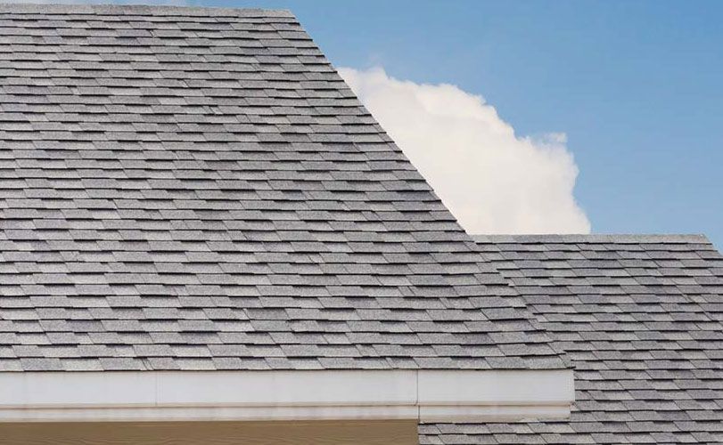 A close up of a roof with a blue sky in the background.