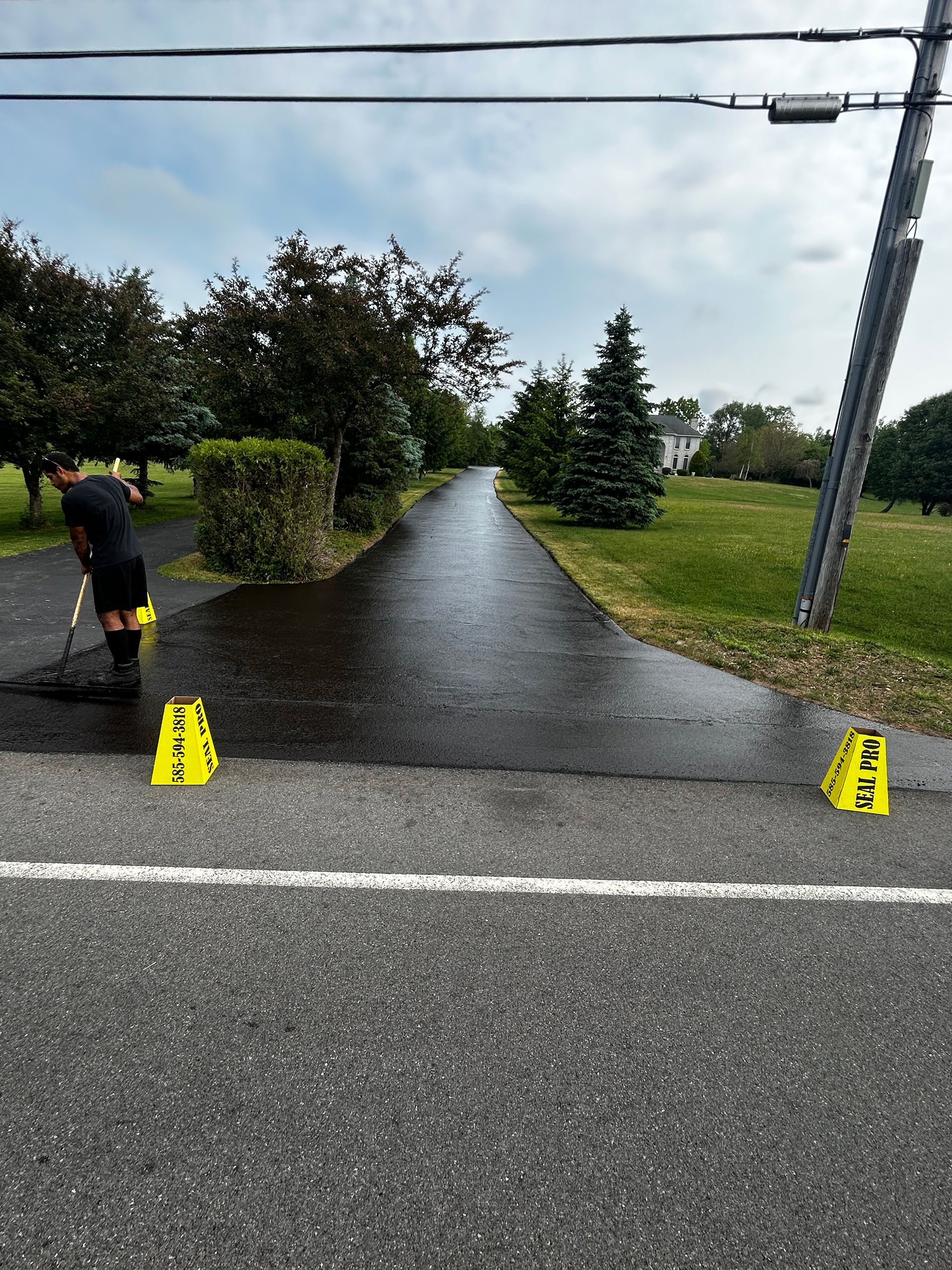 a person is cleaning a road with a broom
