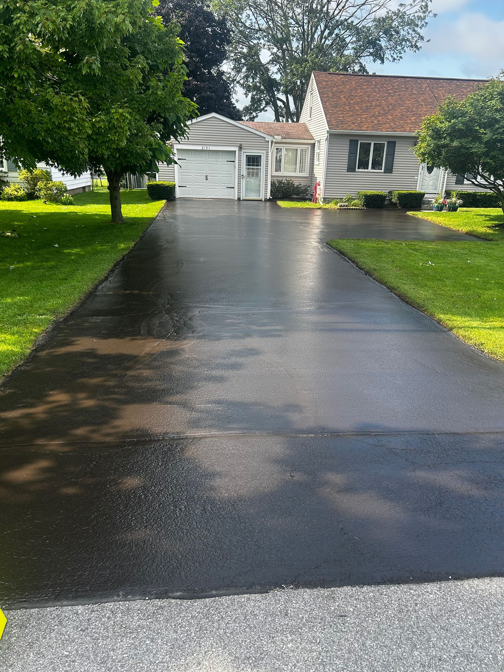 a driveway leading to a house with a garage