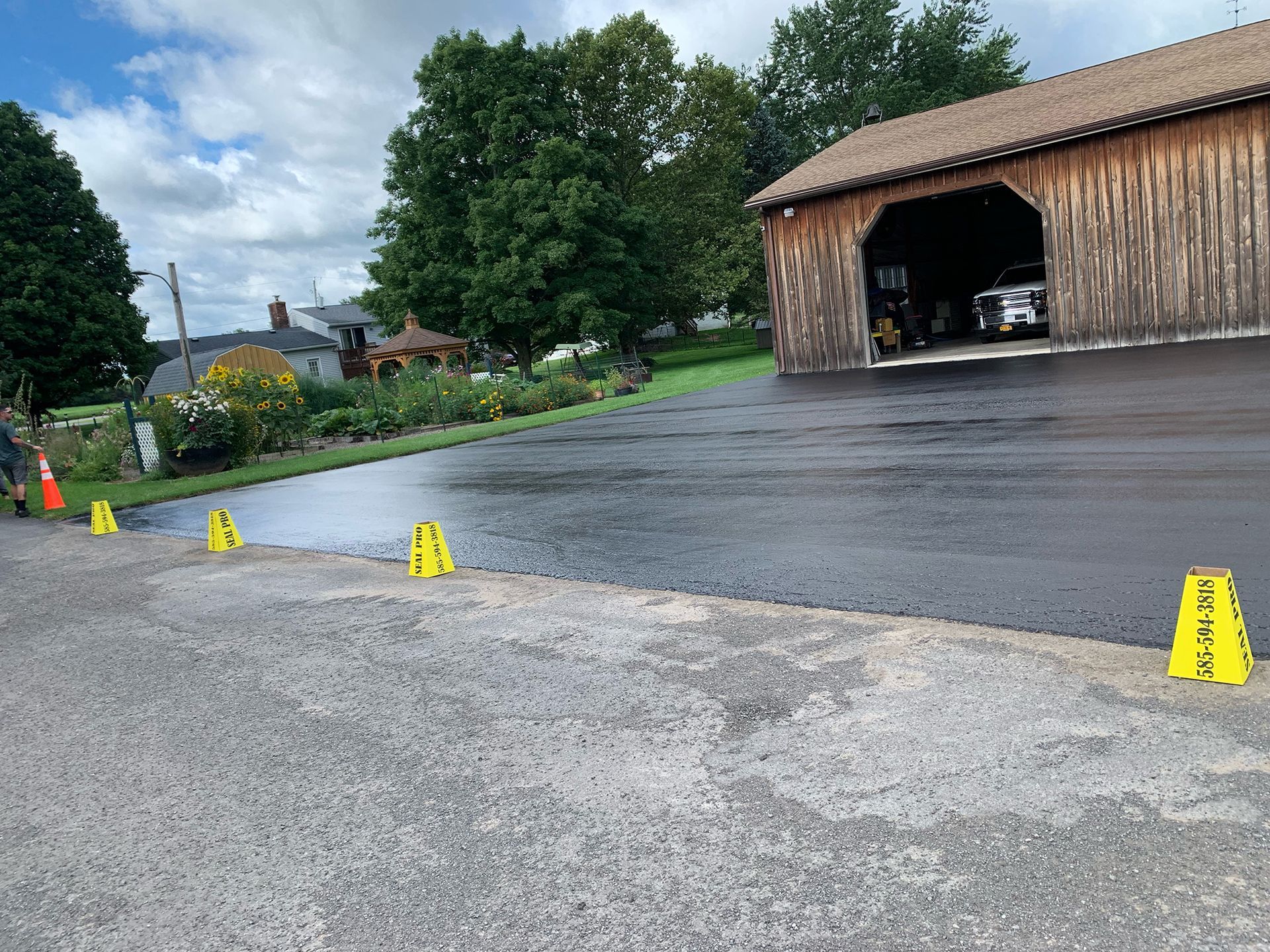 a parking lot with a covered barn in the background