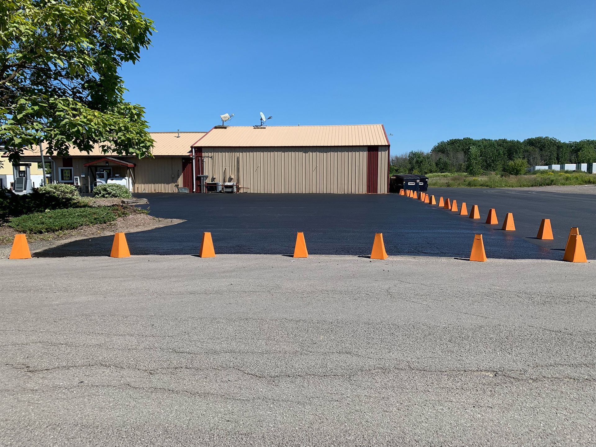 a parking lot with orange cones in front of a building