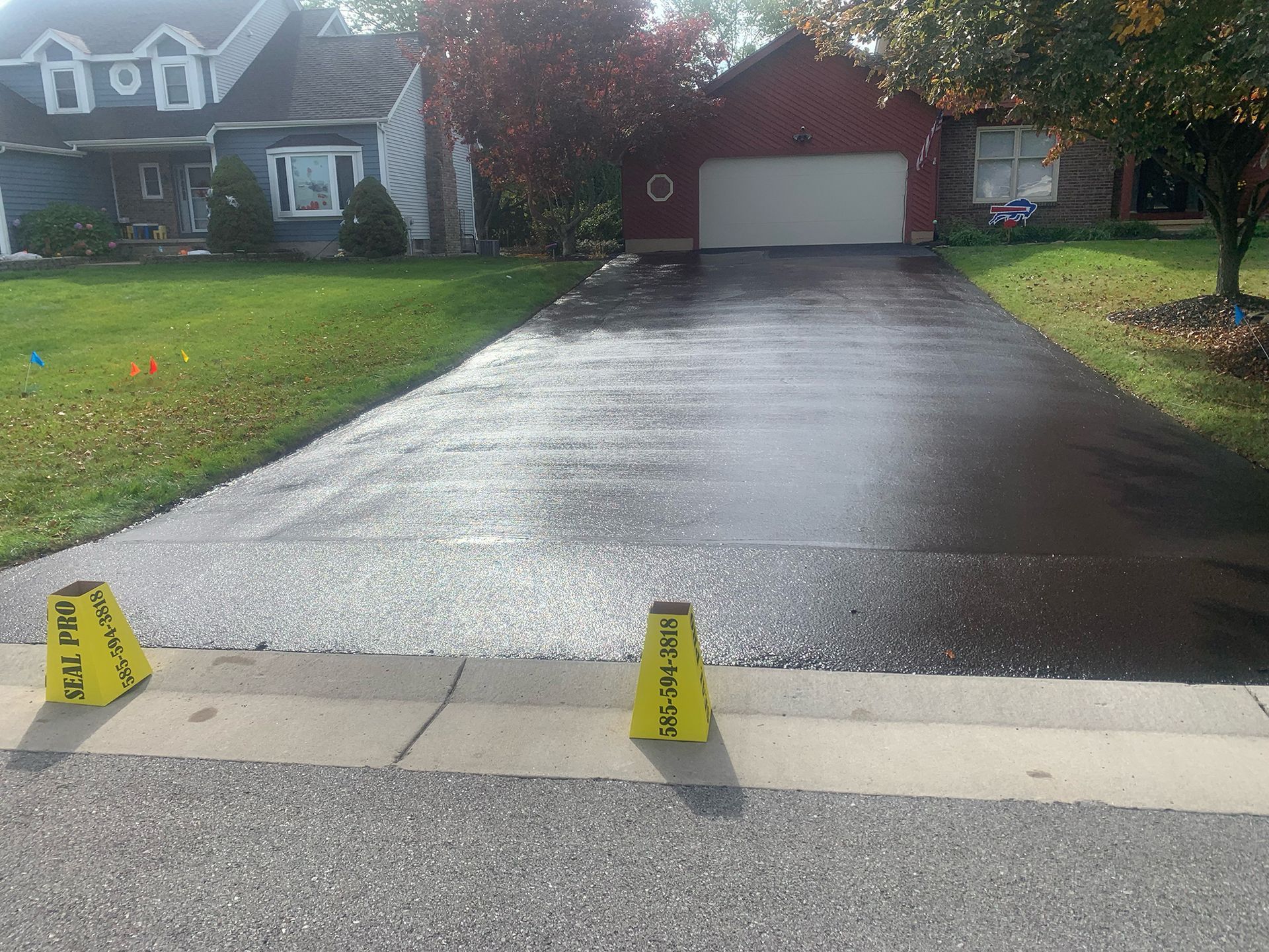 a driveway with a red house in the background