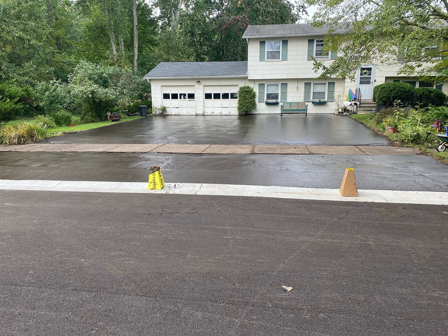 a house with a large driveway and a fire hydrant in front of it