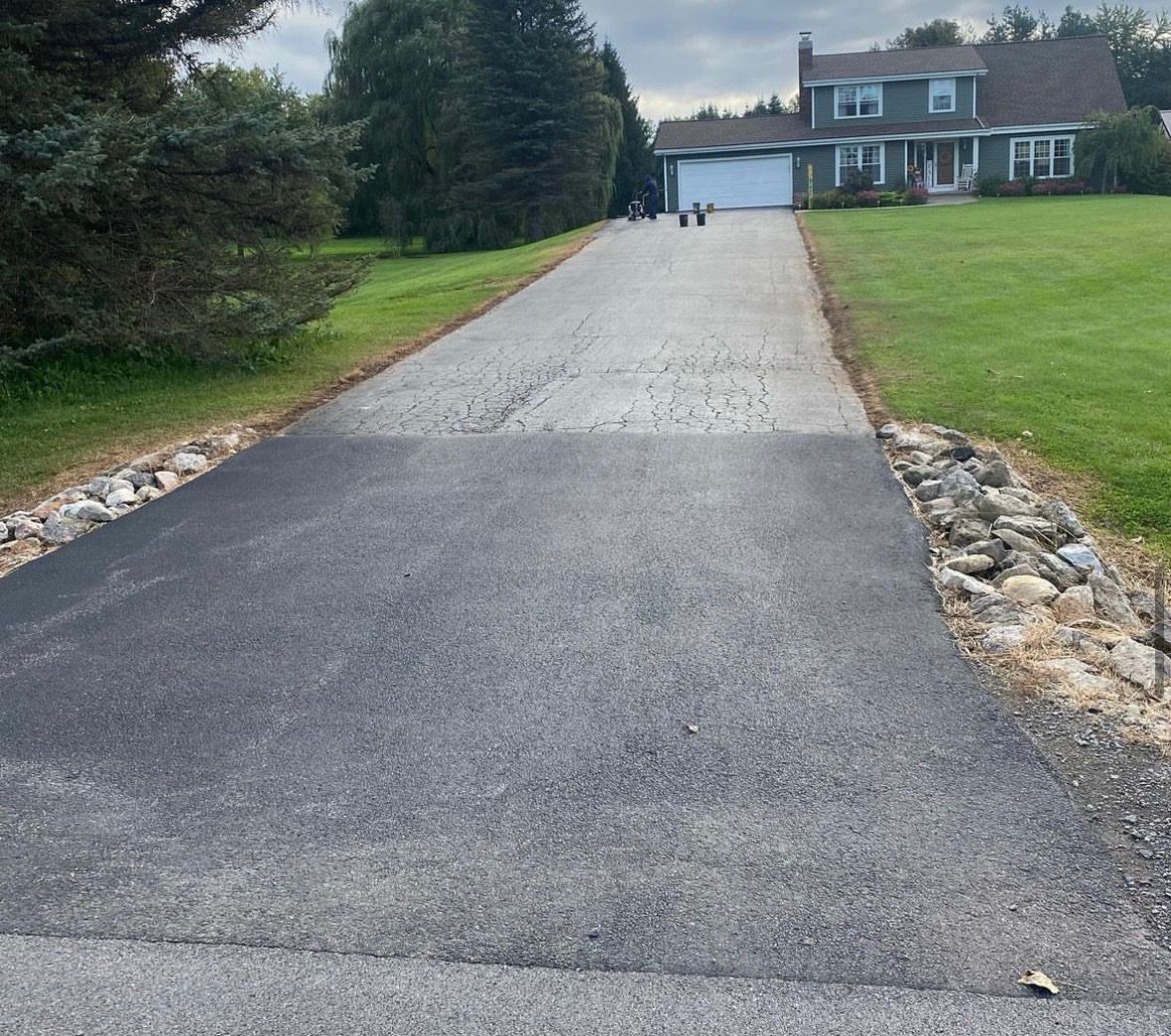 a driveway leading to a house with a garage
