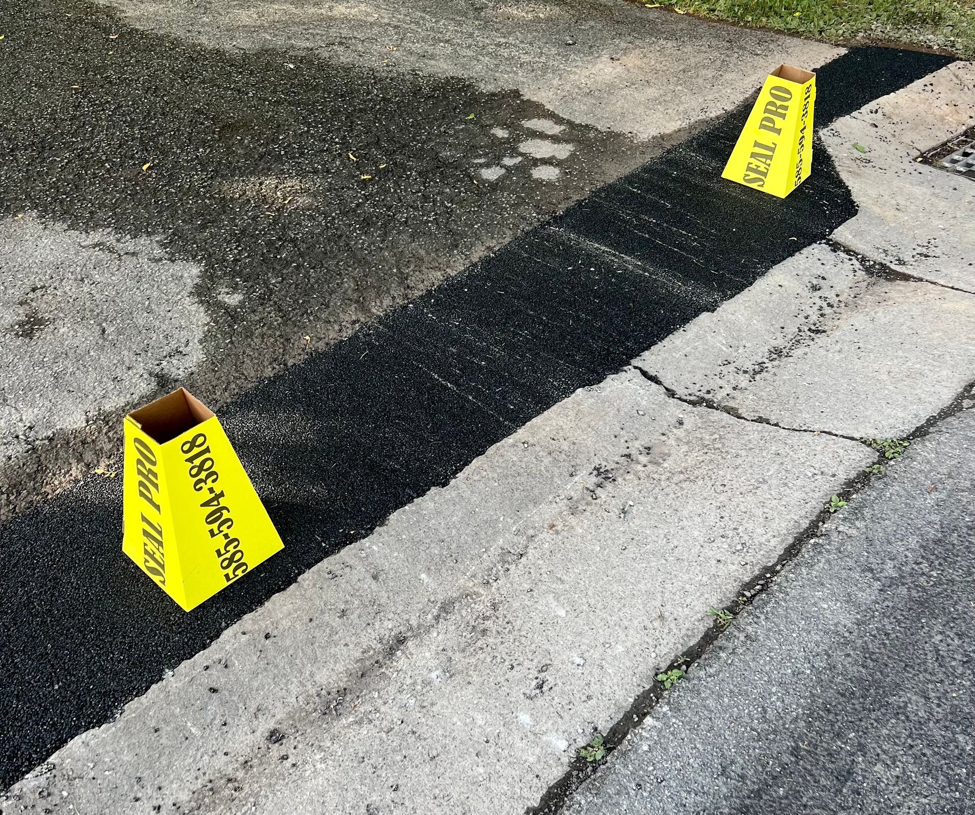 two yellow signs are sitting on the side of a road
