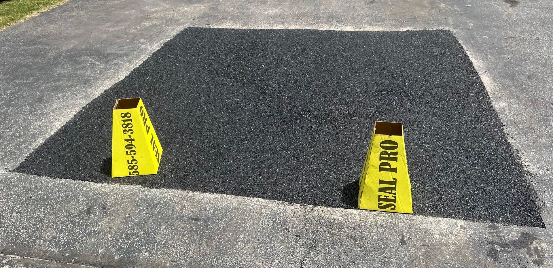 two yellow cones are sitting on top of a concrete surface