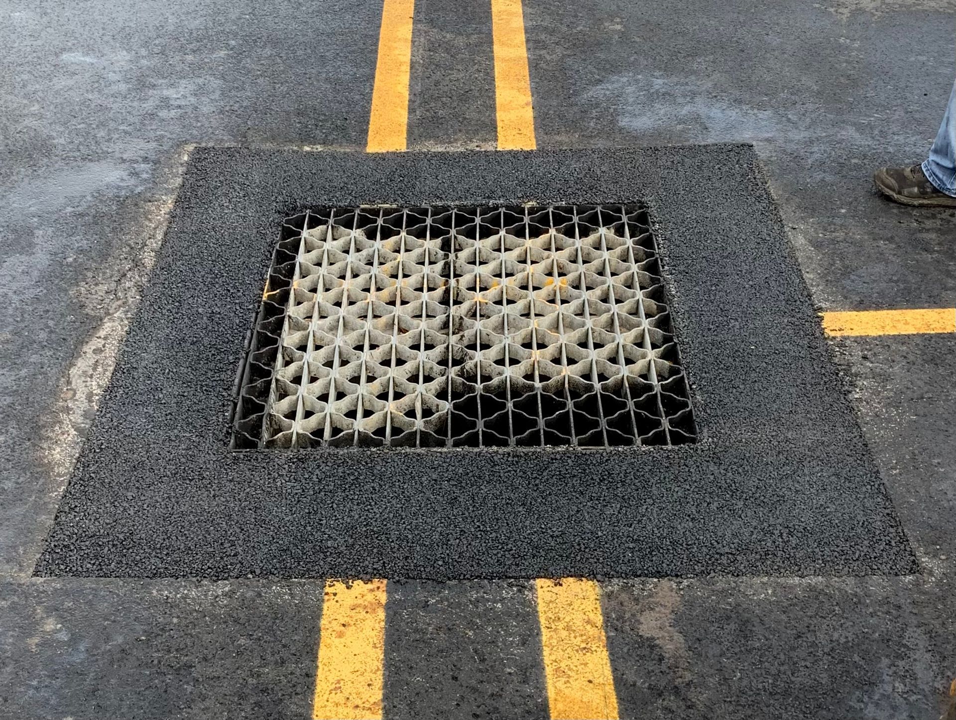 a manhole cover is sitting in the middle of a parking lot