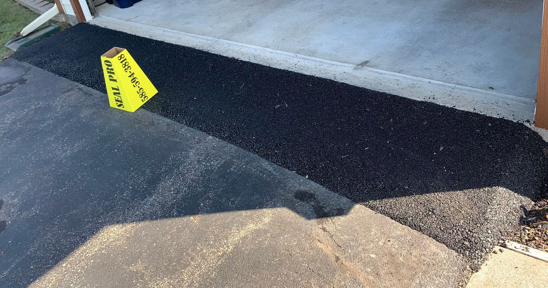 a yellow sign is sitting on the side of a road
