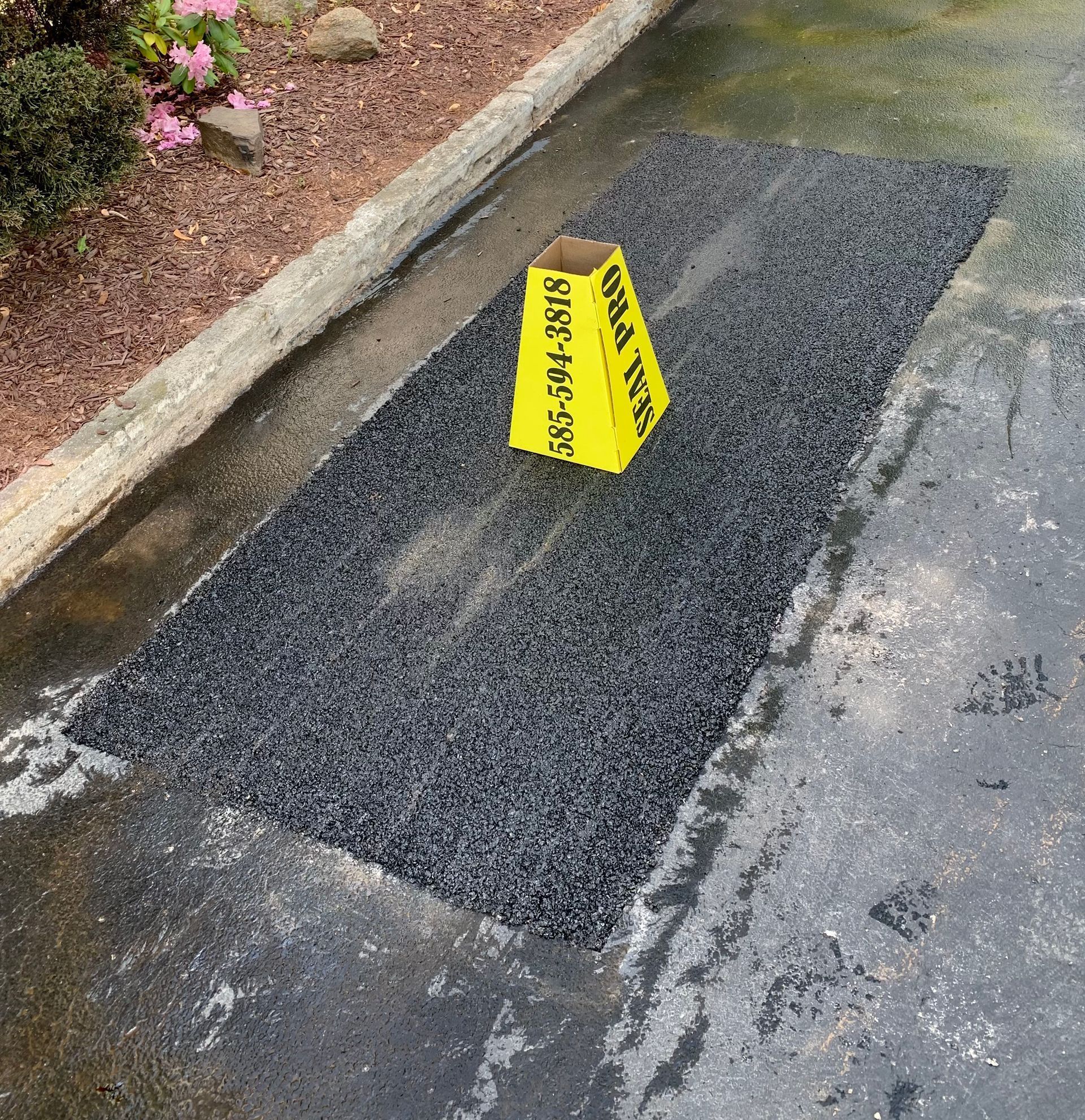 a yellow caution sign is sitting on the side of a road