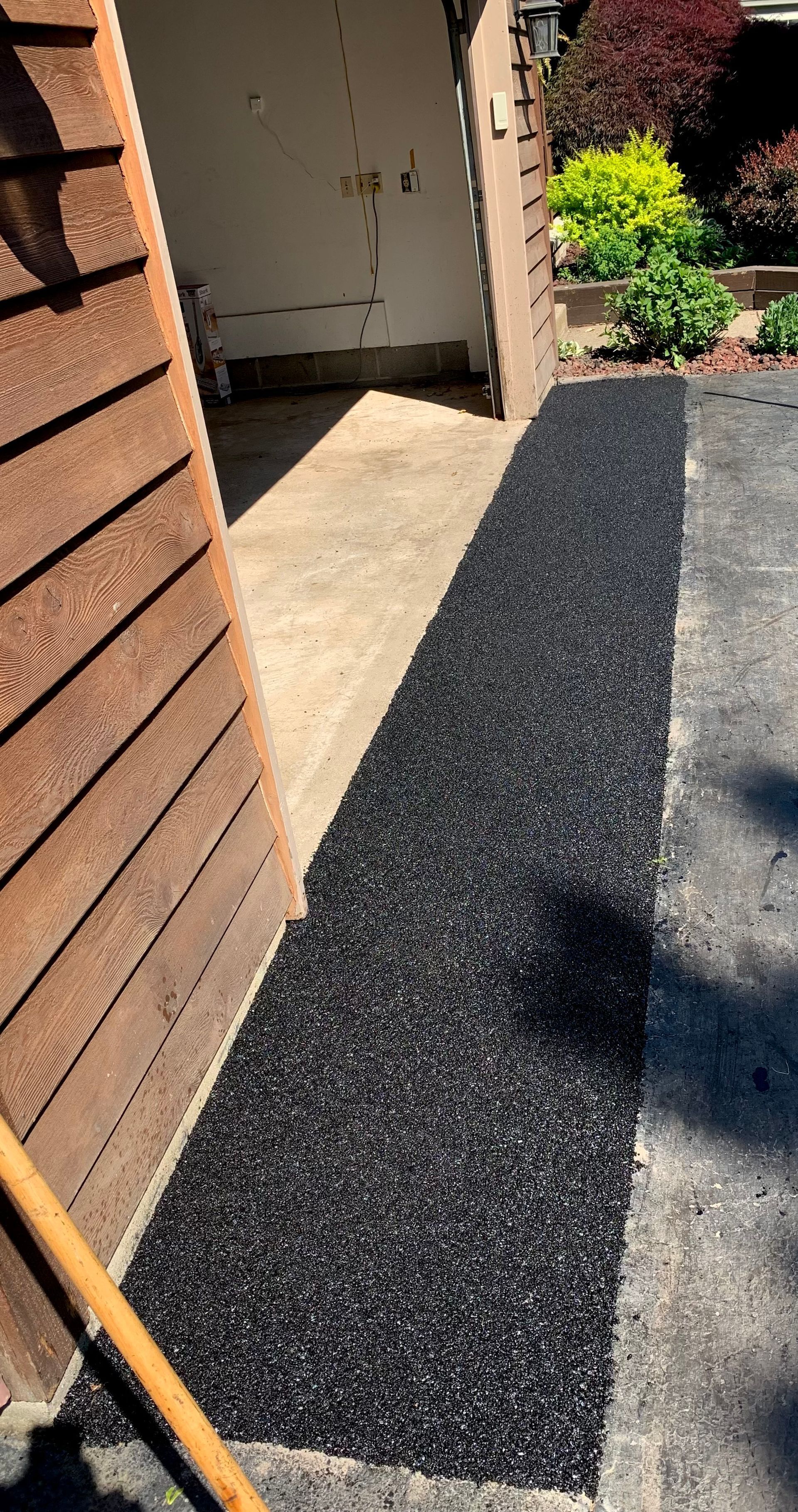 a broom is sitting on a sidewalk next to a house