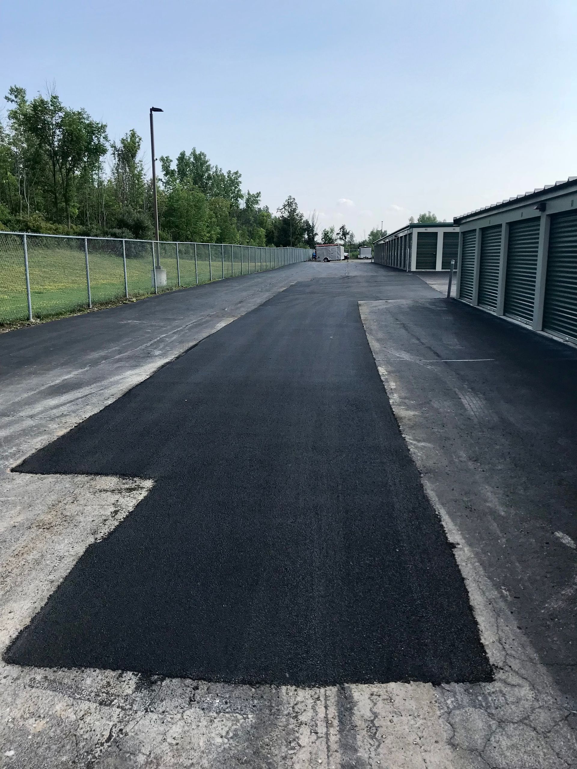 a black asphalt road with a white arrow in the middle