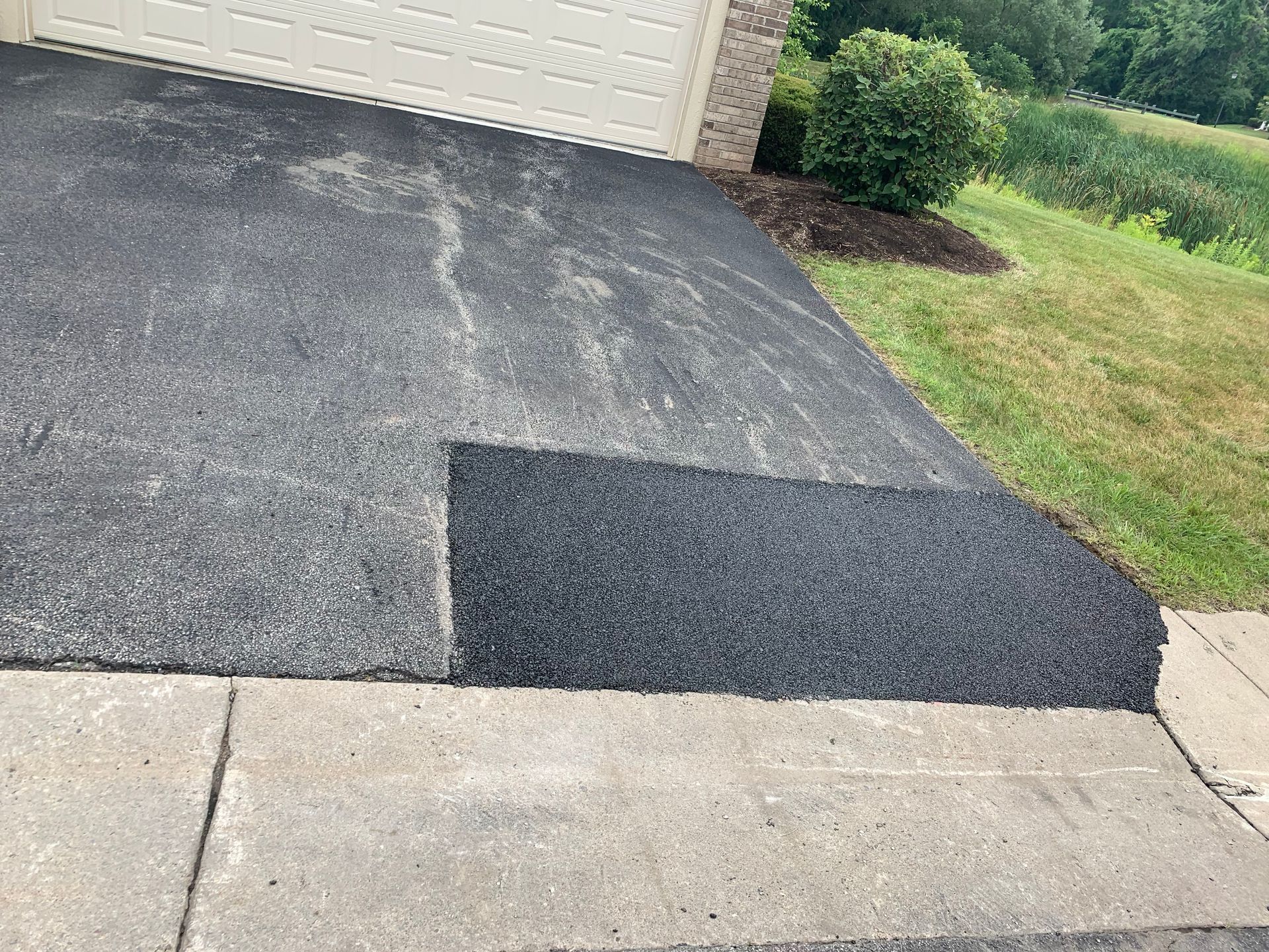 a driveway is being repaired in front of a garage