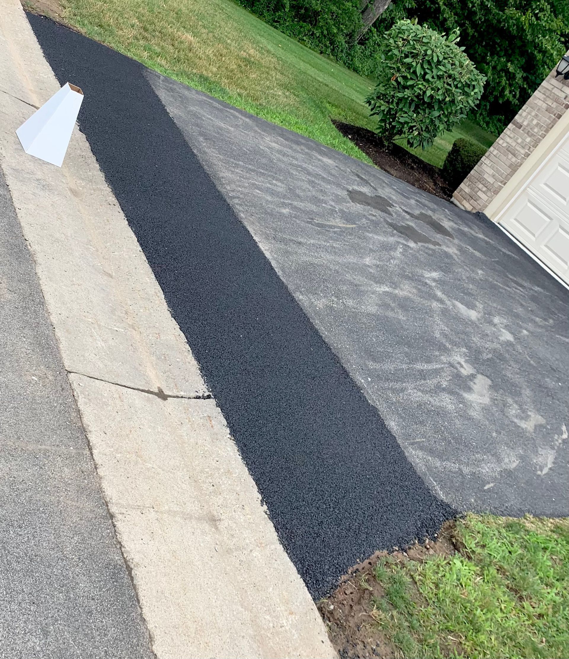 a concrete curb is being installed on the side of a driveway