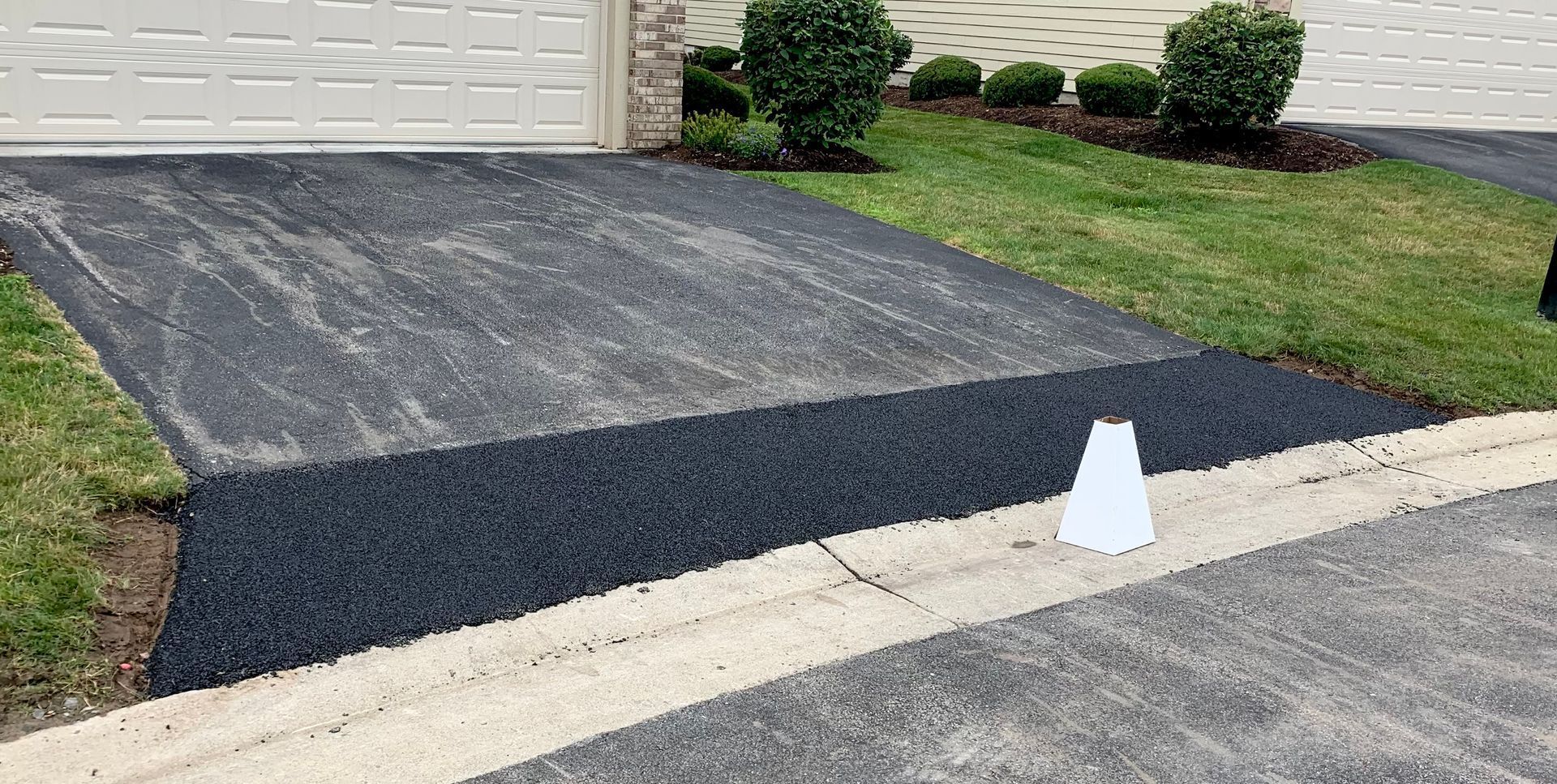 a driveway is being paved in front of a house