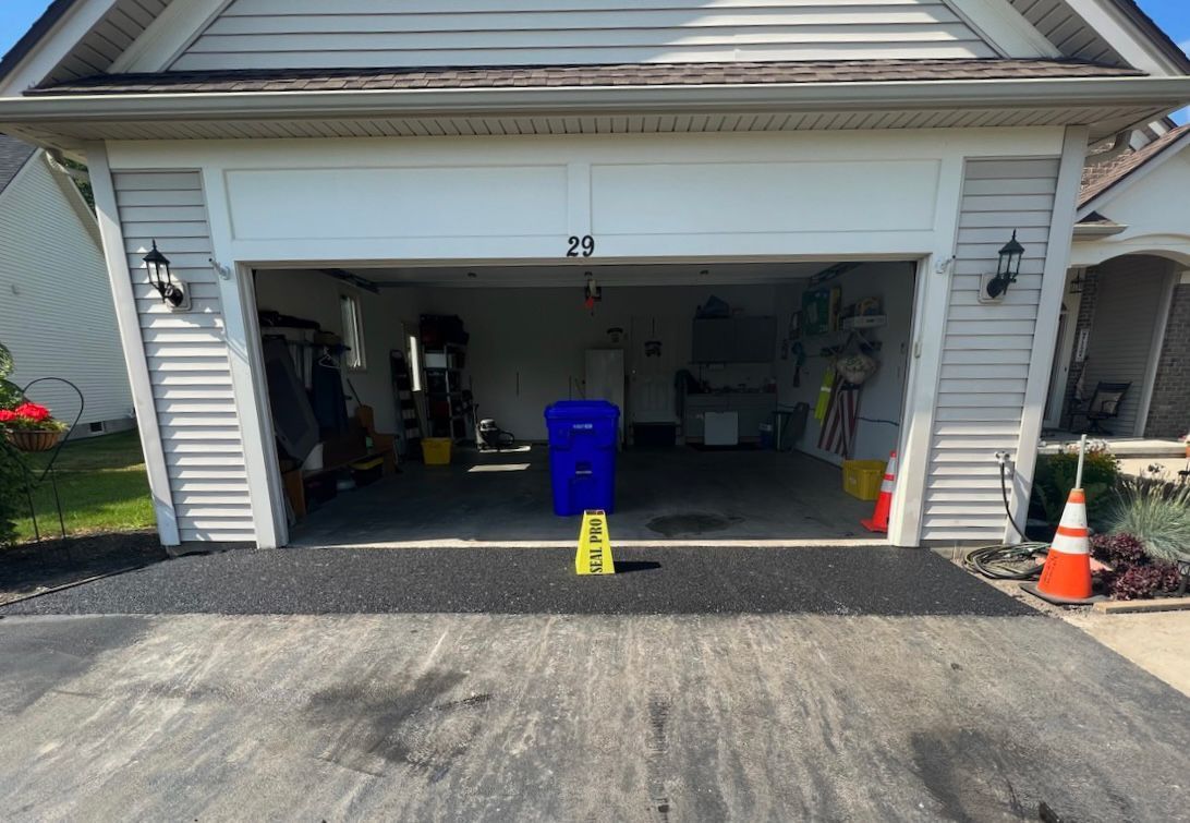 a garage with the door open and a yellow stool in front of it