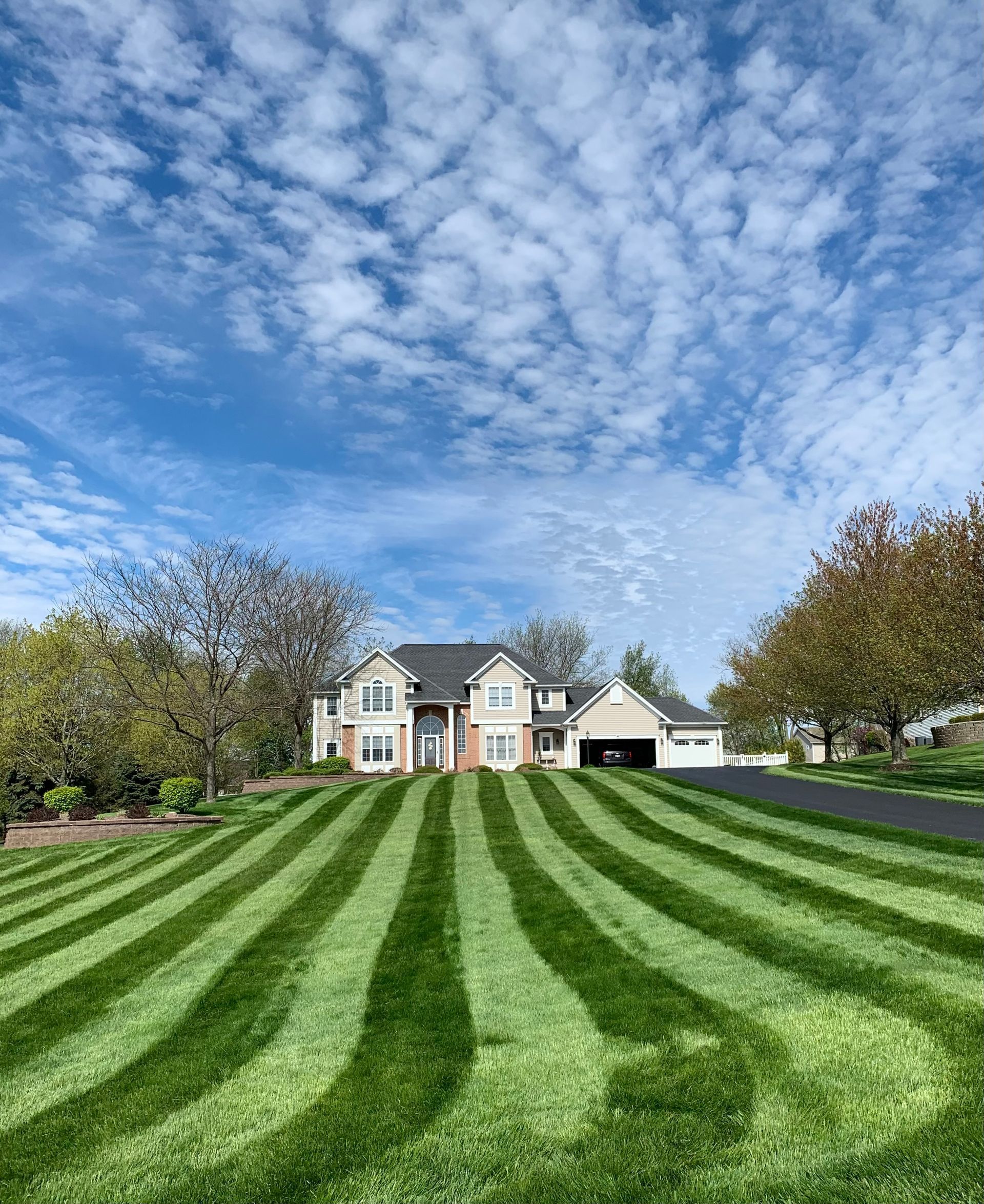 a large house with a lush green lawn in front of it