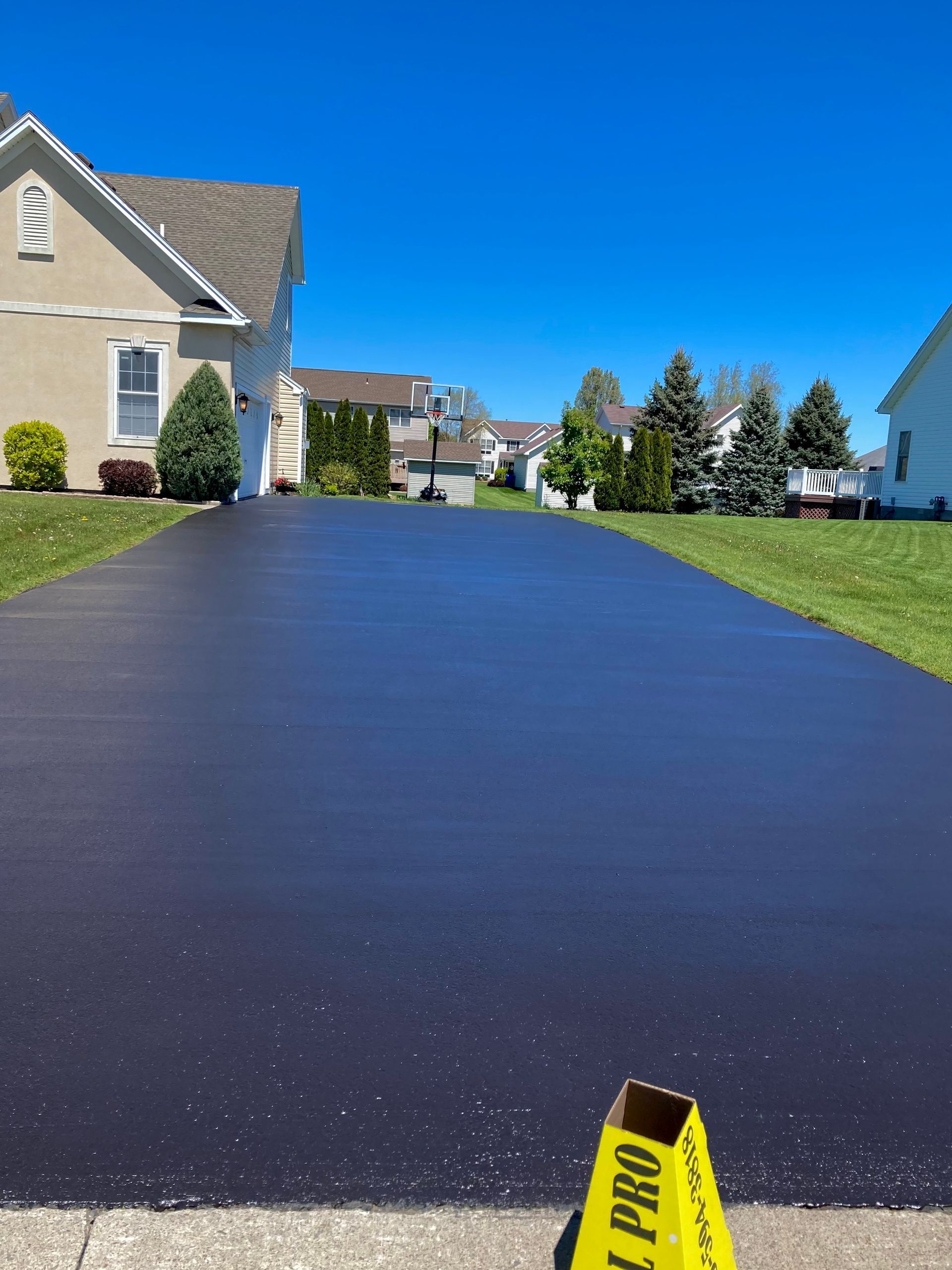a driveway with a yellow cone