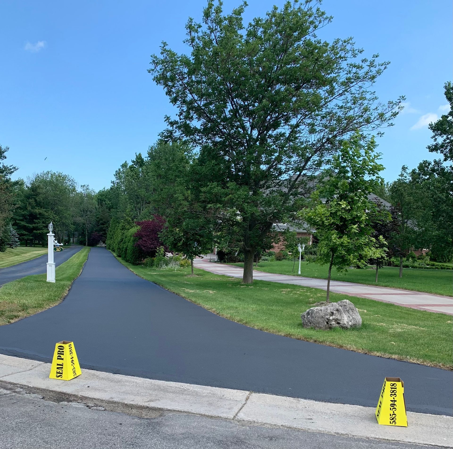 two yellow warning cones on the side of a road