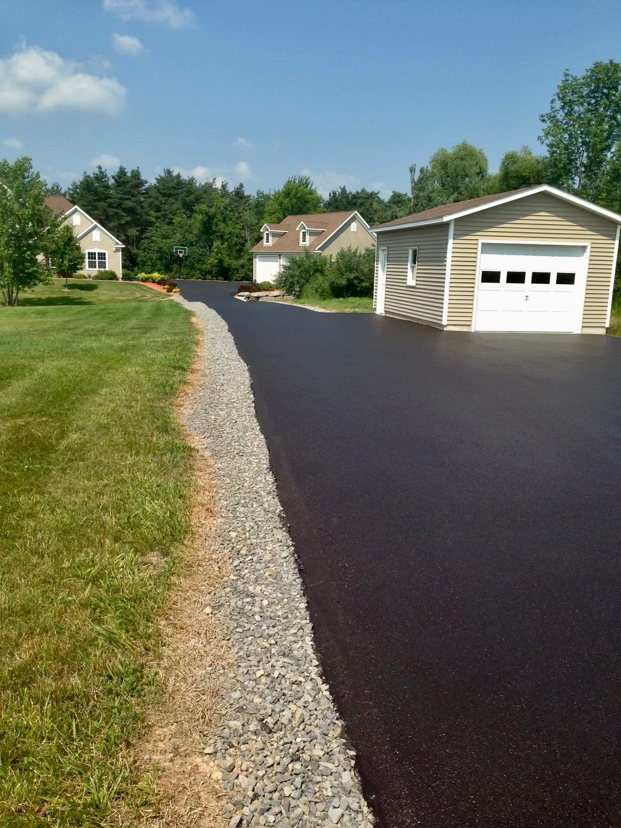 a driveway with a garage in the middle of it