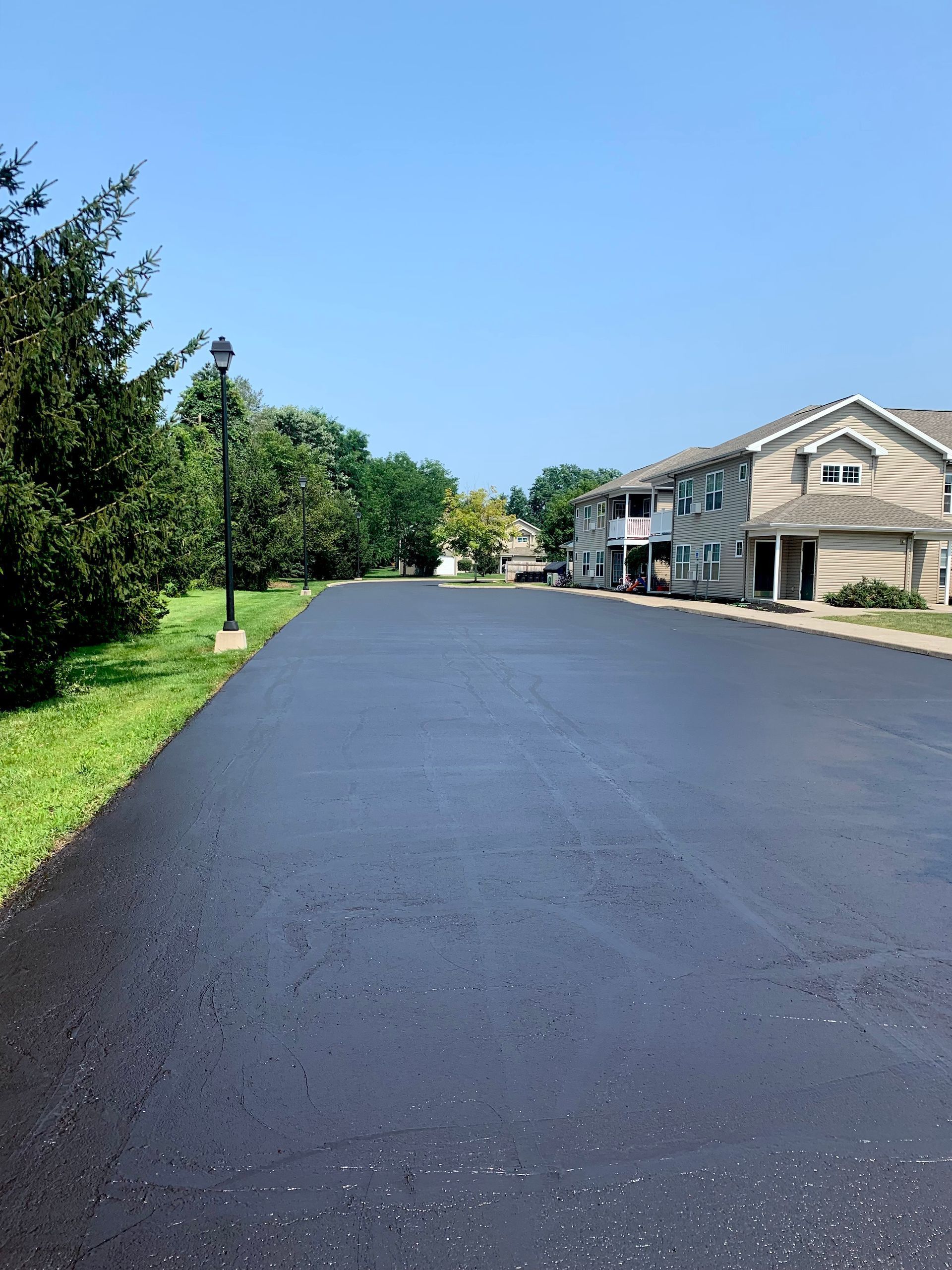 a row of houses are lined up along a paved road