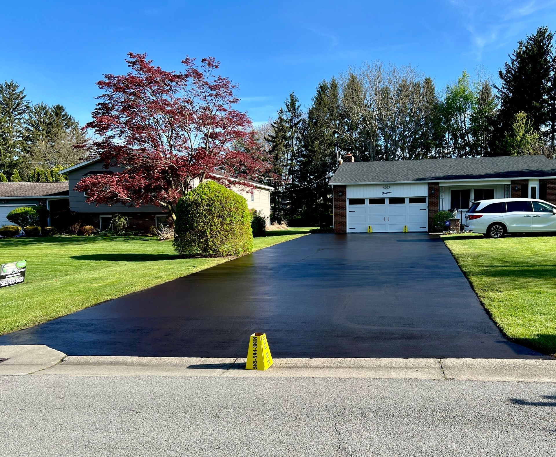 A sealcoated driveway in front of a house