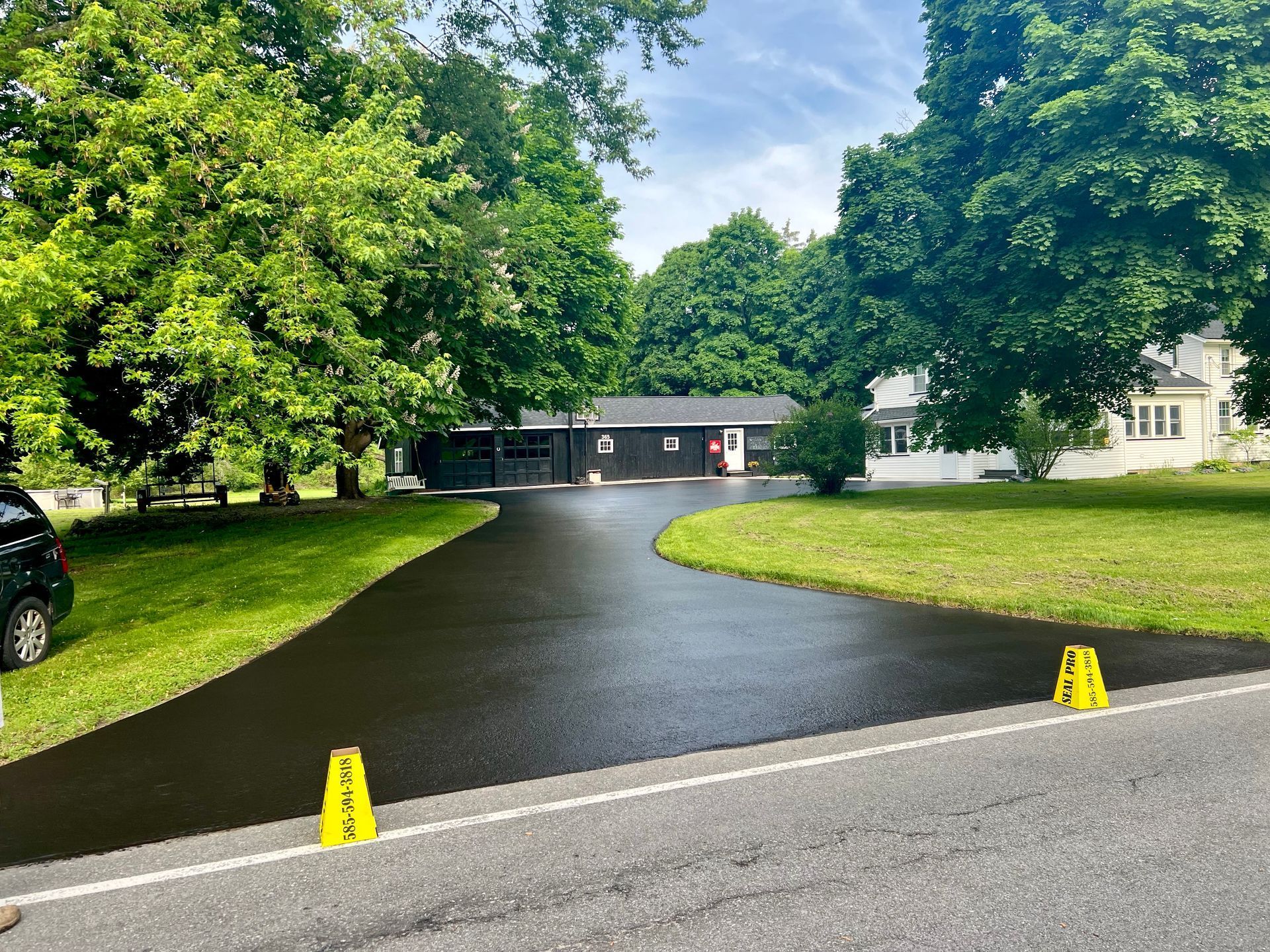 A sealcoated driveway in front of a house