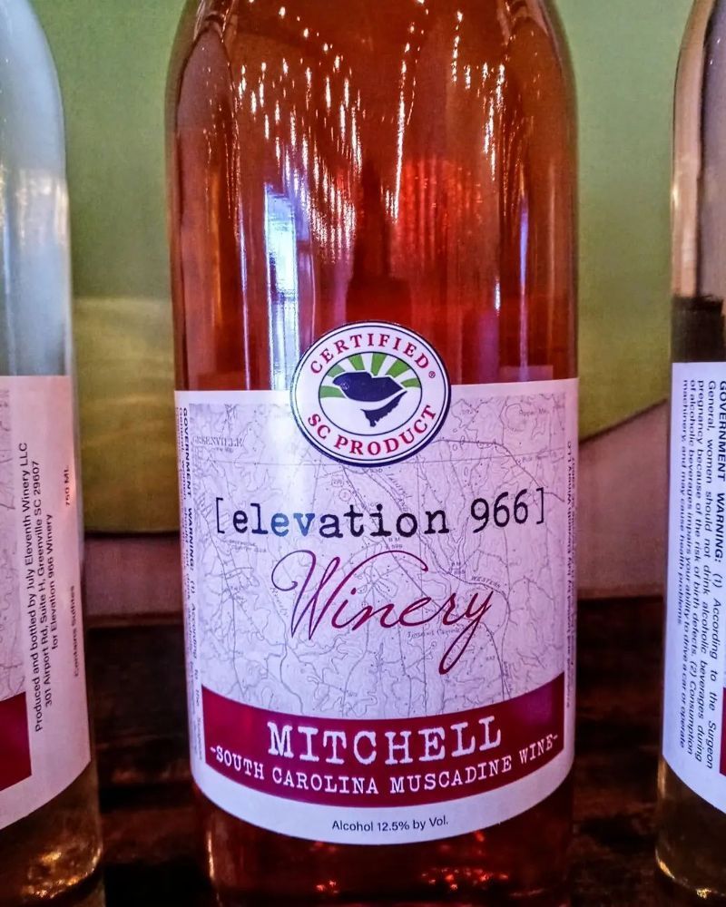 A bottle of mitchell winery wine sits on a table