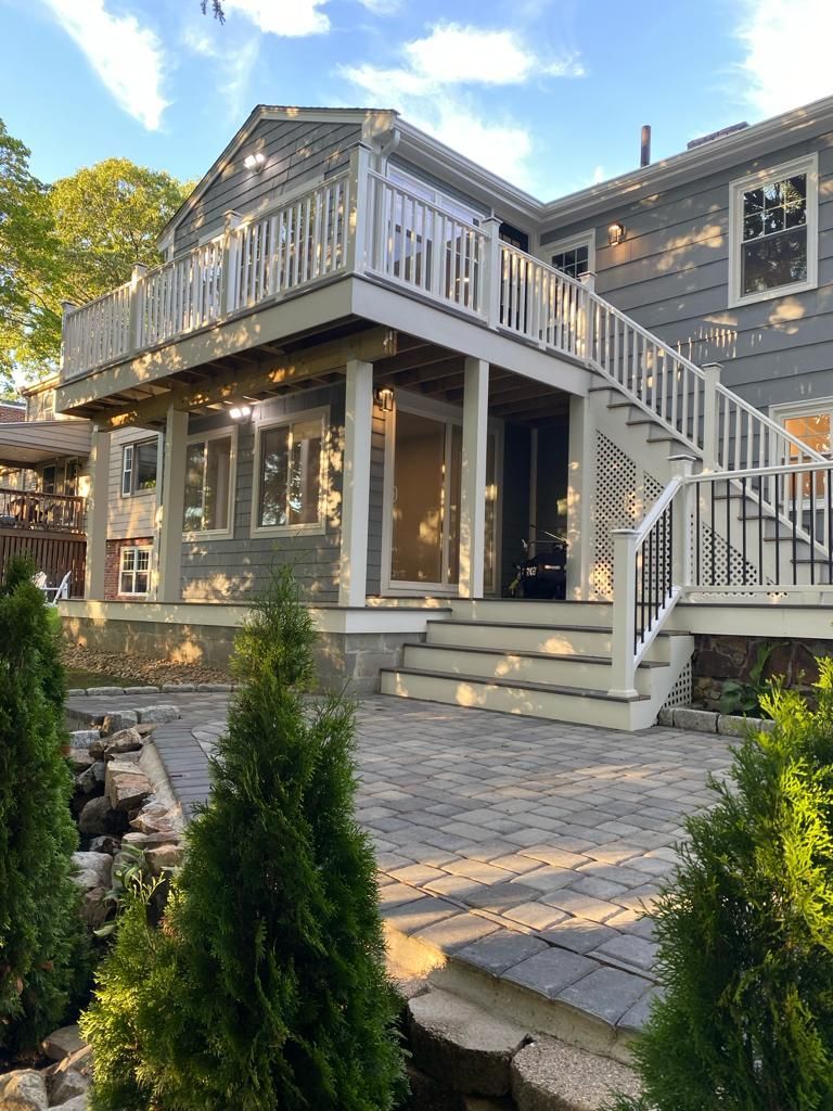 a large house with a large deck and stairs leading up to it