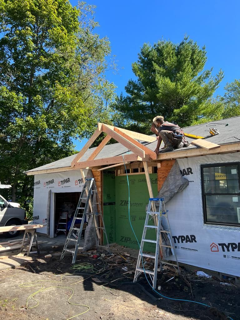 a man is working on the roof of a house