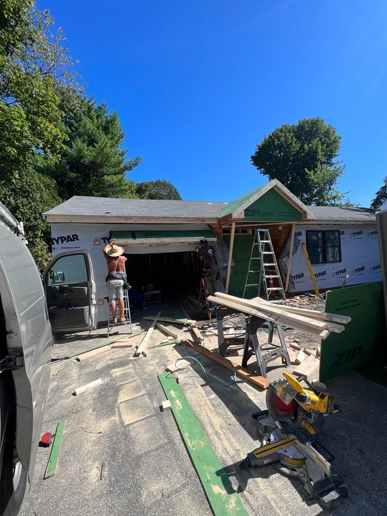 a man is standing in front of a house being remodeled