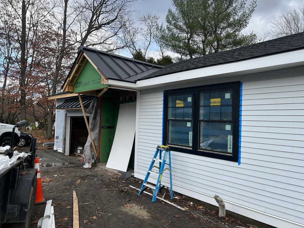 a ladder is sitting on the side of a house under construction