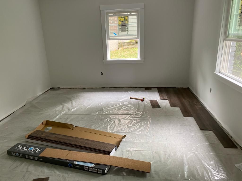 a room with hardwood flooring being installed in it