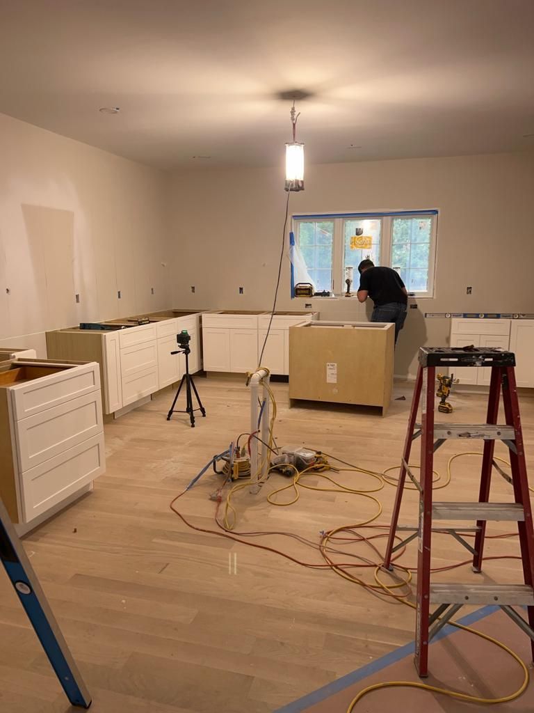 a man is working on a counter in a kitchen under construction