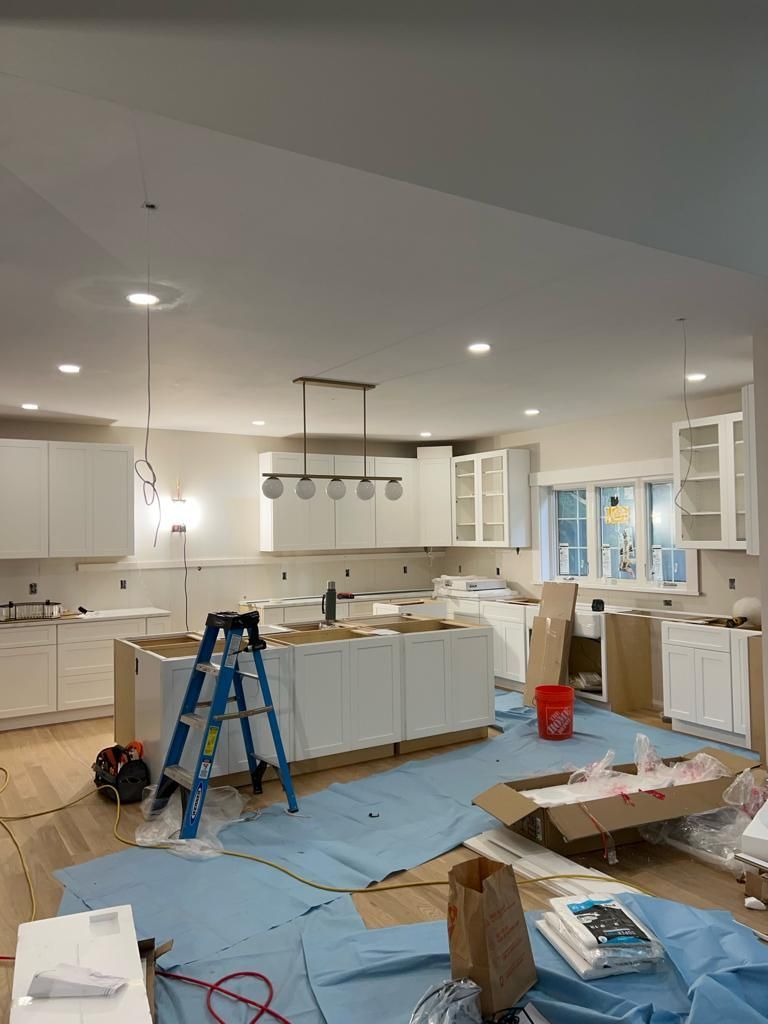 a kitchen under construction with a ladder in the middle of the room