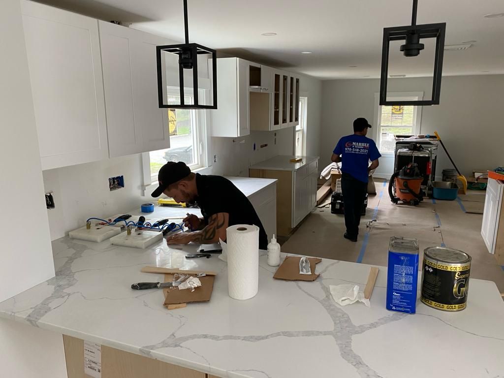 a man is working on a counter in a kitchen