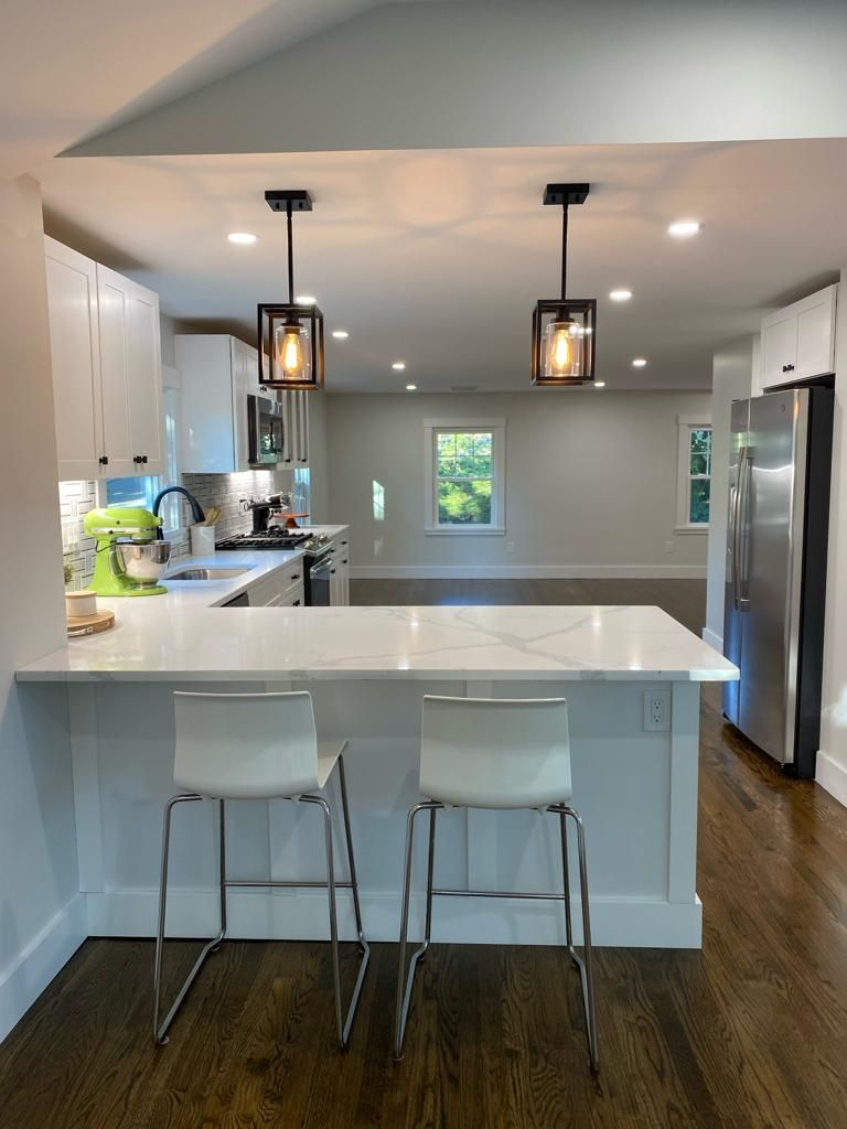 a kitchen with a large island and two stools