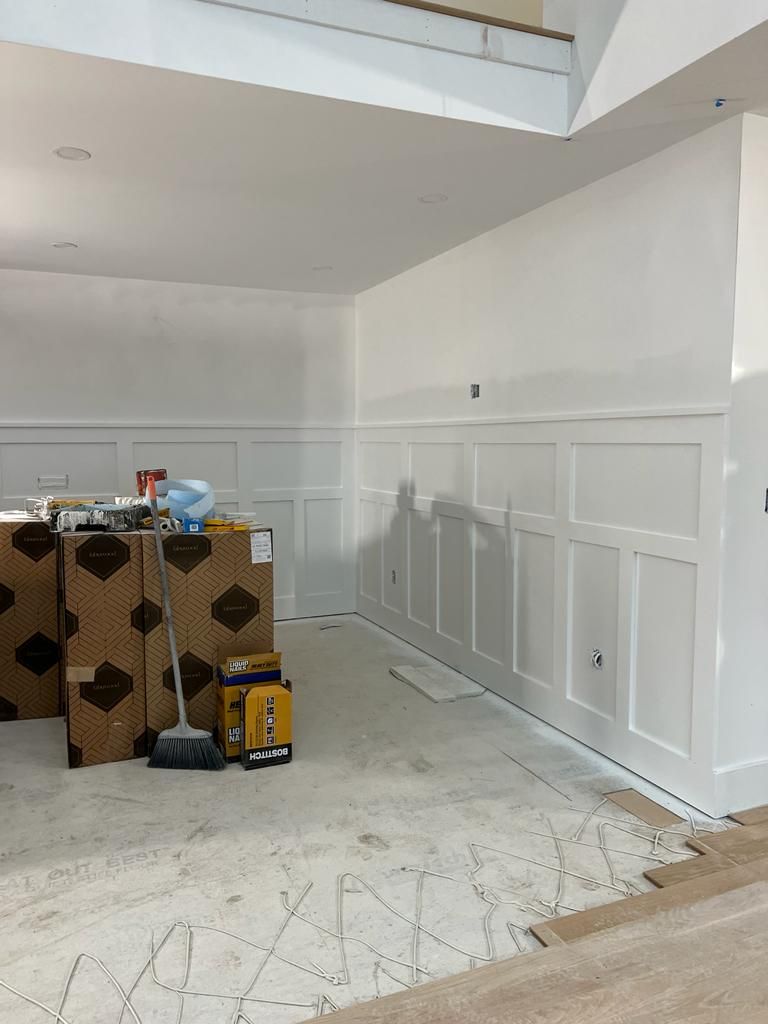 a room with white walls and boxes on the floor